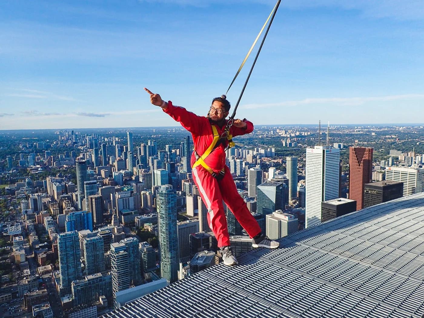 Harnessed participants on the CN Tower EdgeWalk, above the city of Toronto.