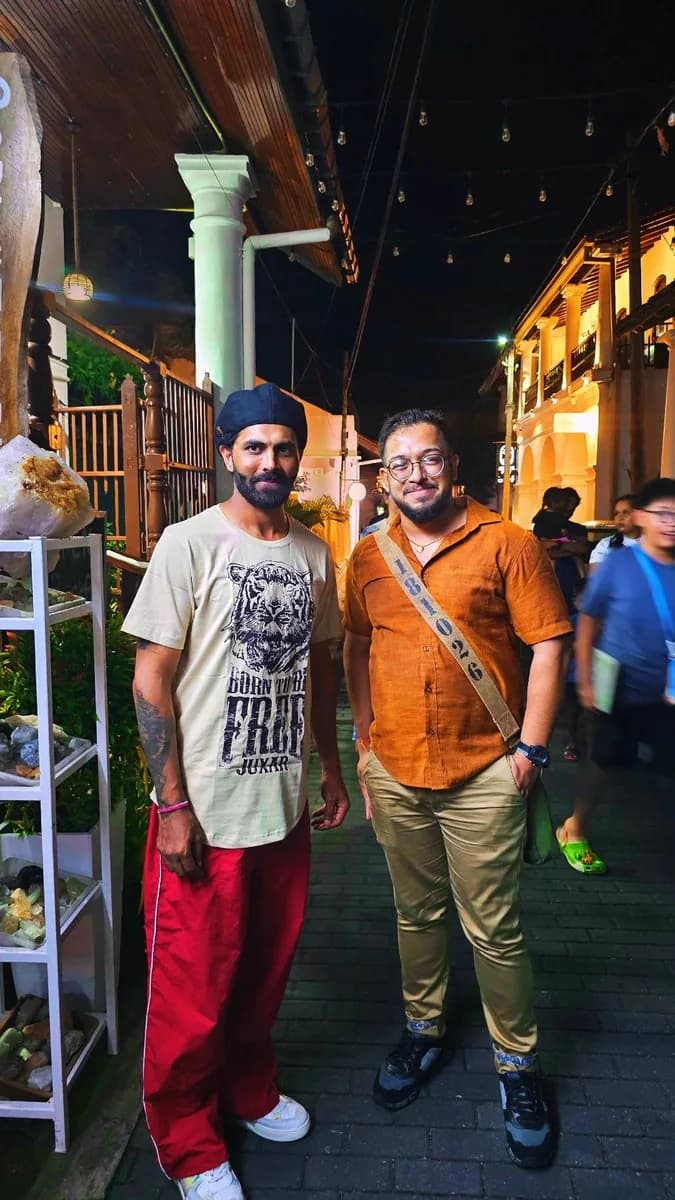 Ashish and Ravindra Jadeja standing together outdoors at night in Sri Lanka.