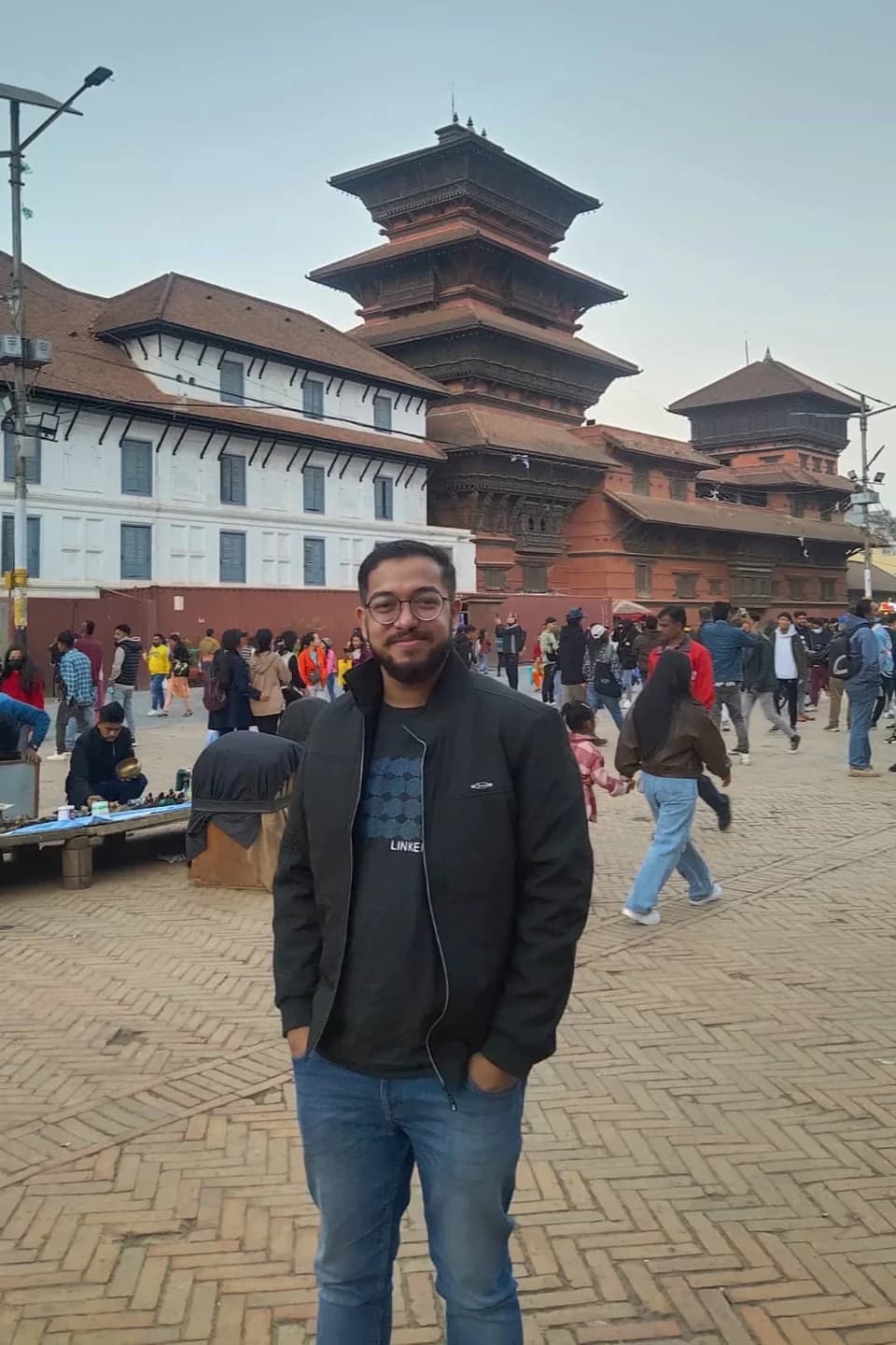 Ashish standing in Kathmandu Durbar Square, with tiered temple roofs behind him.